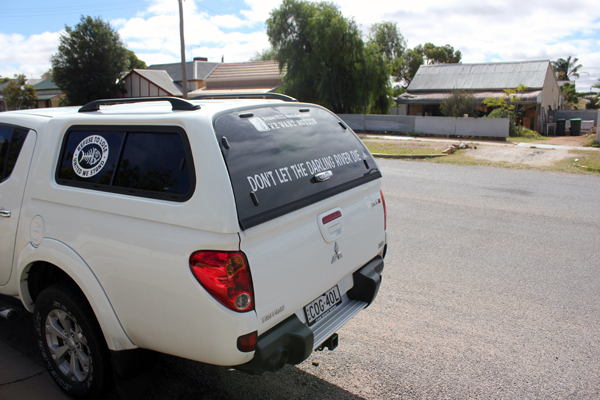 A car with stickers saying "Don't Let the Darling River Die"